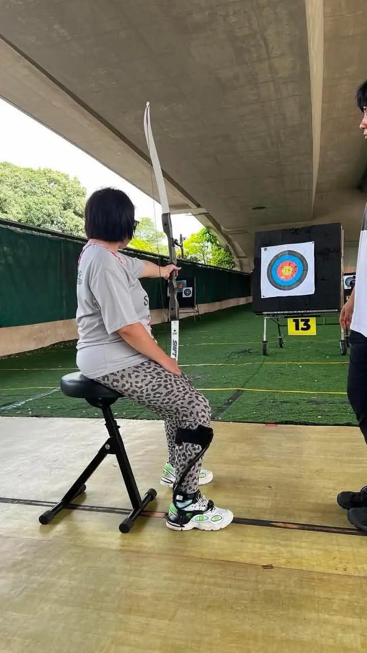 Maya Seah using adaptive archery as part of her stroke recovery journey, showing focus, adaptation and the courage to aim forward in Singapore